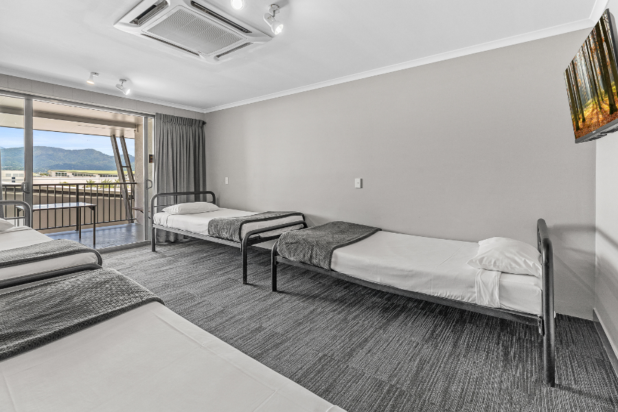 4-Bed Deluxe Dorm - ©King single beds, balconies, smart TV’s, a mini fridge, and private en-suite facilities.