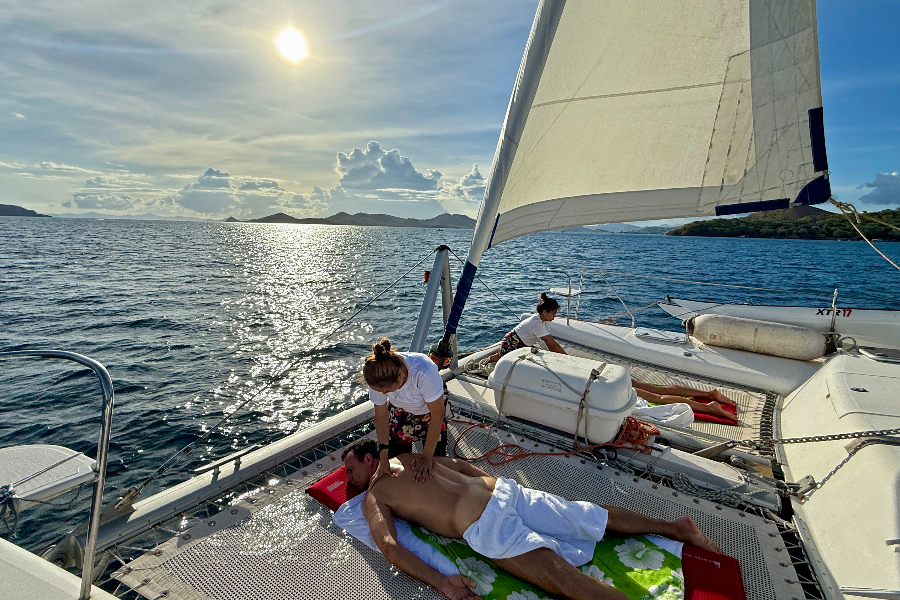 Couple's massage on Tribal Adventures catamaran trampoline after soaking in hot springs on your way back from your Coron Island exploration day