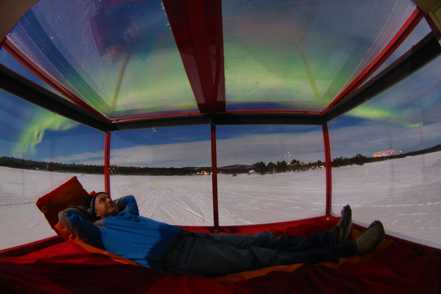Northern lights from inside our Mobile Cabin on lake ice. - ©Mobile Cabins Finland
