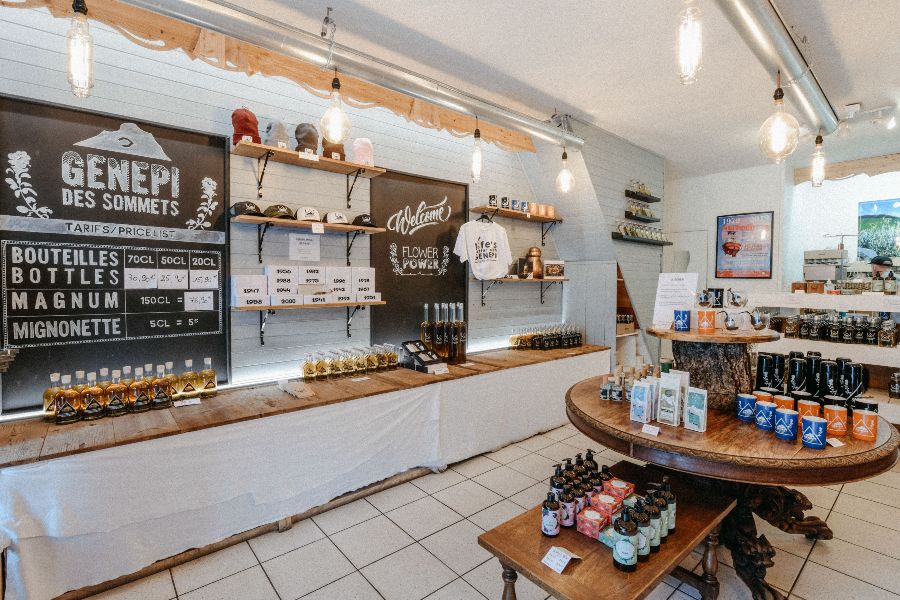 Vue de la boutique sur des bouteilles de genépis et des produits types tisanes,