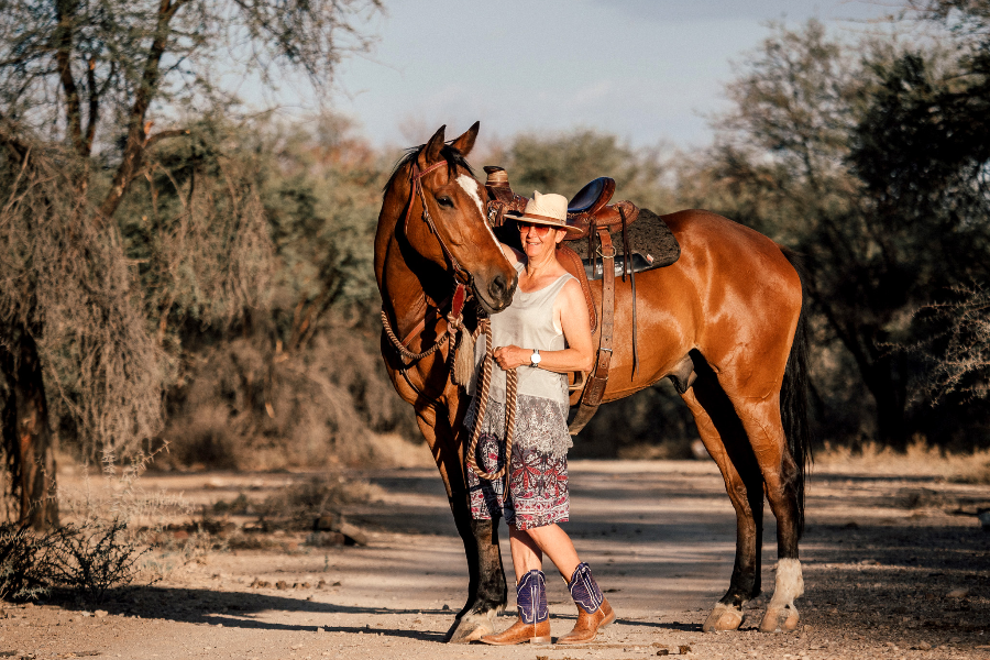 Owner and riding guide Johanna Sauber with stallion Anton at BüllsPort Lodge & Farm, Naukluft, Namibia - ©Marleen Baumann