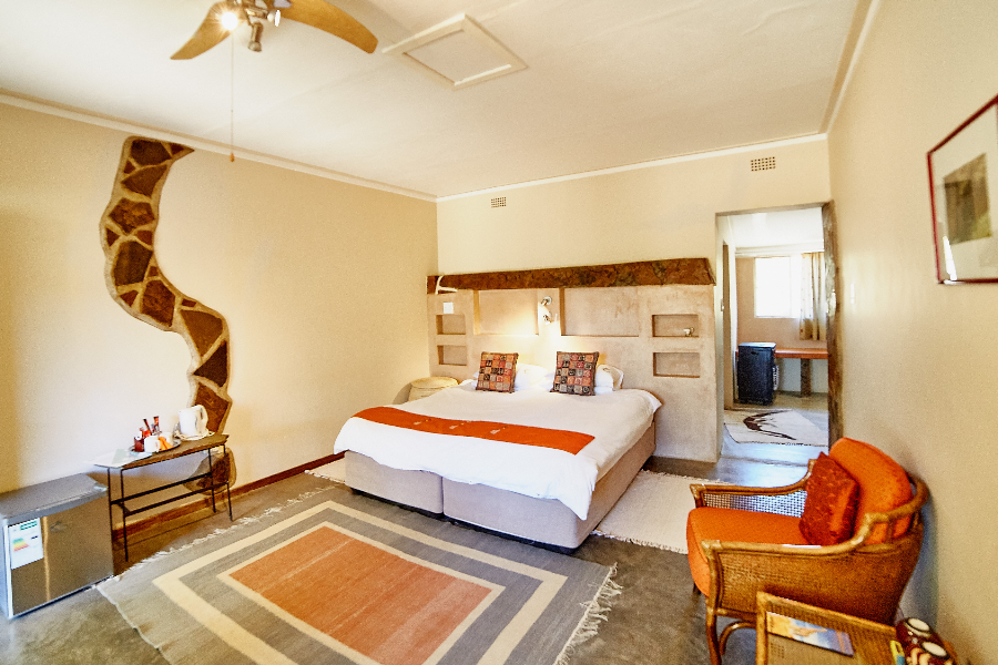 Spacious room with free Wi-Fi, aircon, ceiling ventilator and small fridge at BüllsPort Lodge & Farm at the foot of the Naukluft Mountains, Namibia - ©Ronja Hartmann