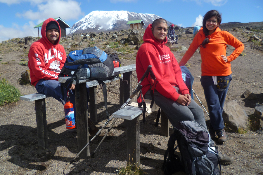 Our Director in the middle enjoying the sun on Mount Kilimanjaro. - ©Shah Tours